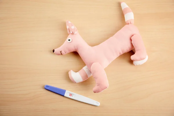 Teste de gravidez e brinquedo bonito — Fotografia de Stock