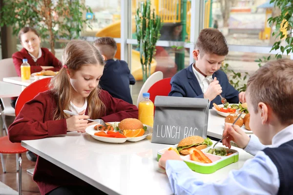 Children eating at the canteen Stock Photo by ©Wavebreakmedia 108962978