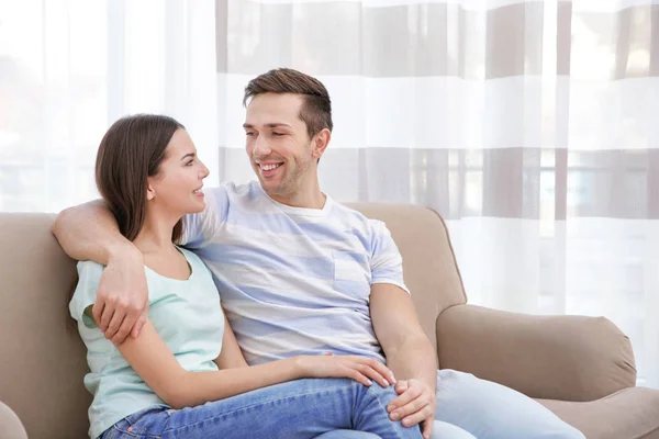 Happy couple resting on couch — Stock Photo, Image