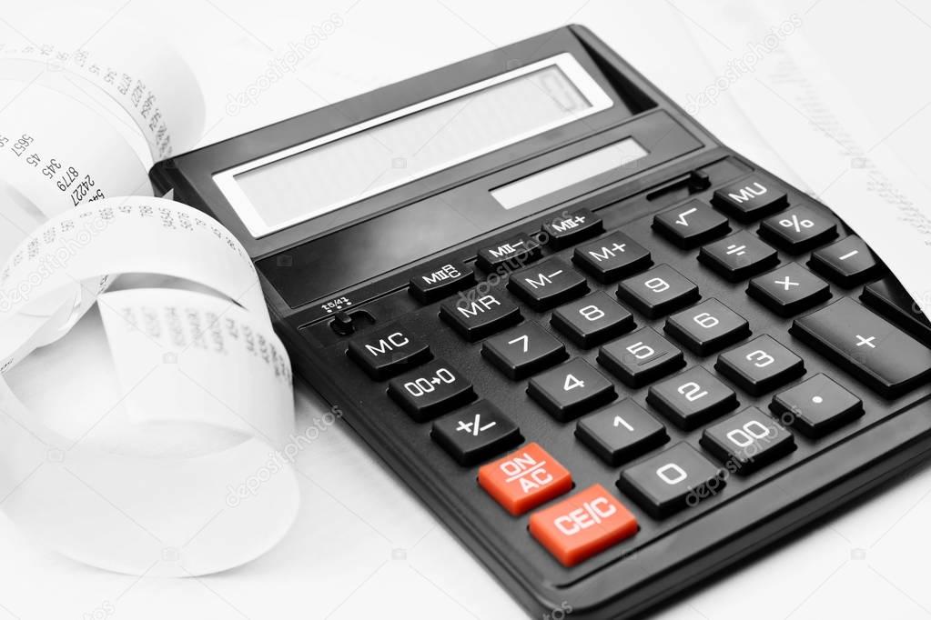 Calculator with adding machine tape, closeup