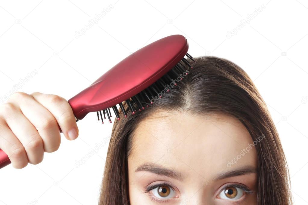 Young woman brushing hair 