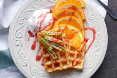 Tasty waffles with delicious fruits clipart