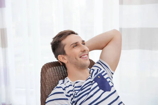 Young man resting on modern chair — Stock Photo, Image