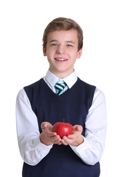 Lindo colegial con manzana sobre fondo blanco — Foto de Stock