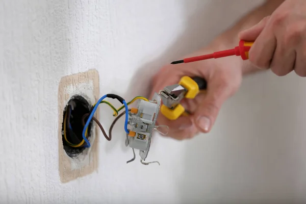 Electrician installing socket — Stock Photo, Image