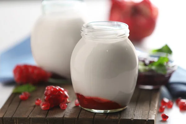 Glass jar with tasty yogurt — Stock Photo, Image