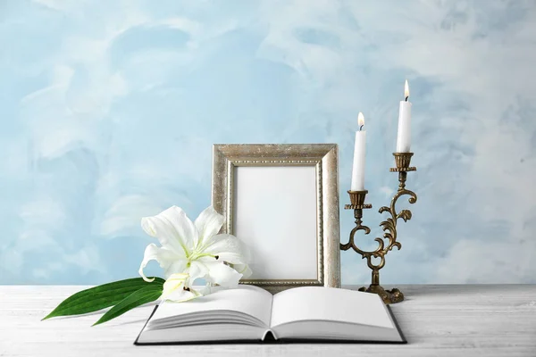 Frame, candles, opened book and lily — Stock Photo, Image