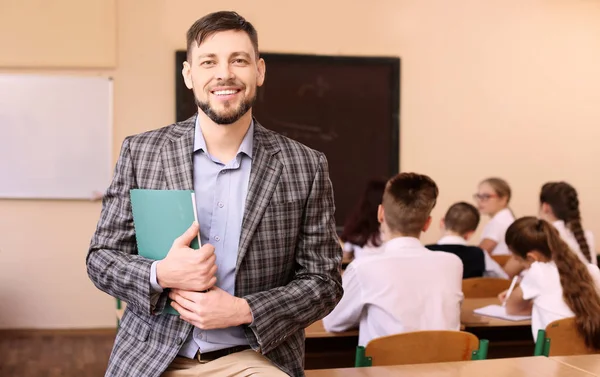 Portrait of happy teacher in classroom — Stock Photo, Image