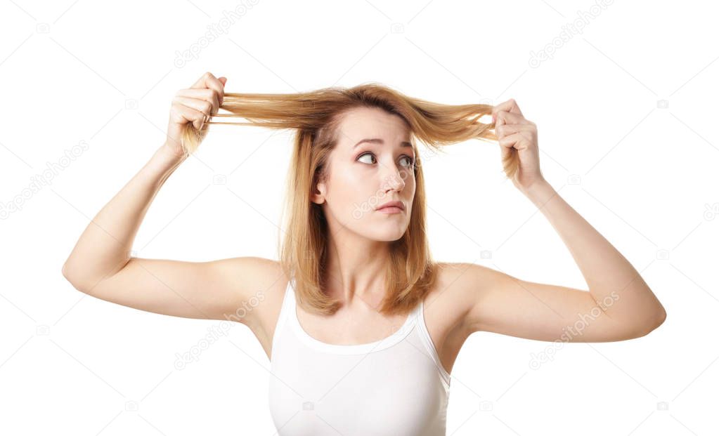 Young woman with hair loss problem on white background