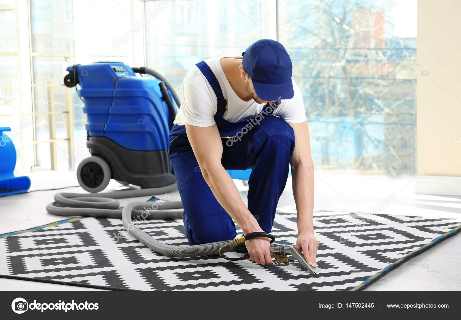 Dry cleaners employee removing dirt — Stock Photo © belchonock 147502445