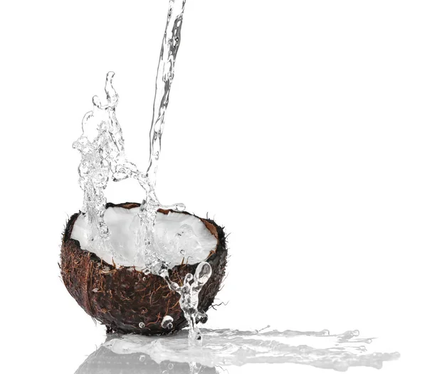 Cracked coconut with jet of water — Stock Photo, Image