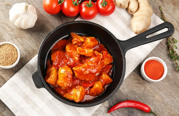 Sartén con delicioso pollo tikka masala en mesa de madera — Foto de Stock