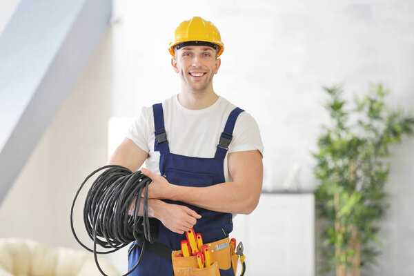 Young electrician with tools 
