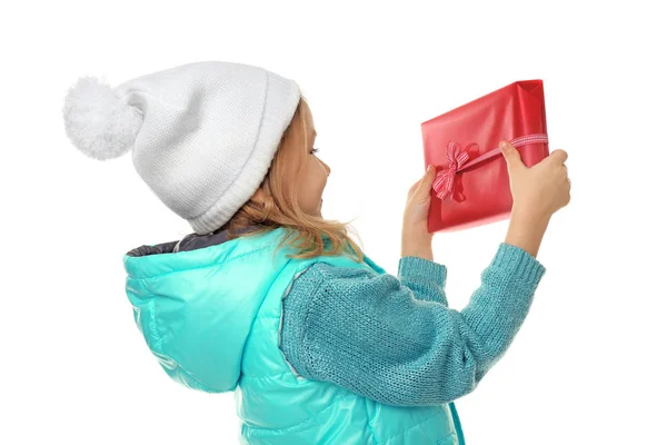 Cute little girl in warm clothes with giftbox on white background — Stock Photo, Image