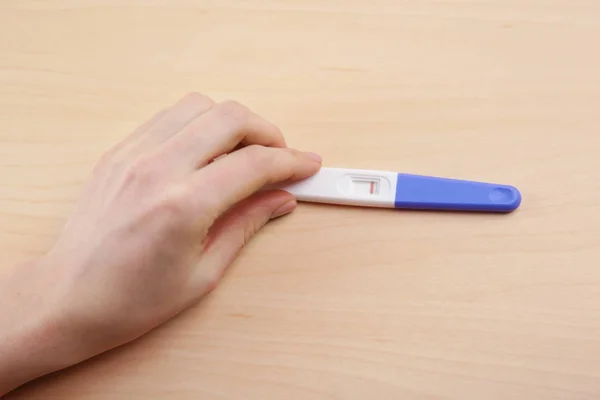 Pregnancy test in hand — Stock Photo, Image