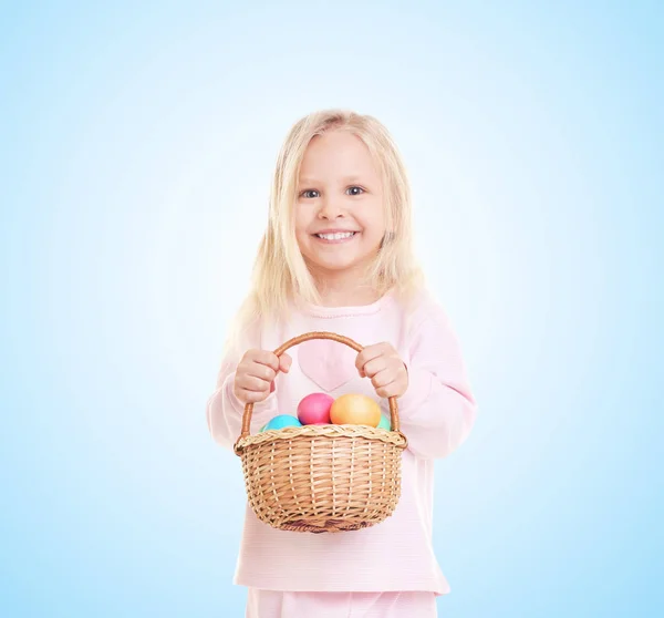Little girl with basket of eggs — Stock Photo, Image