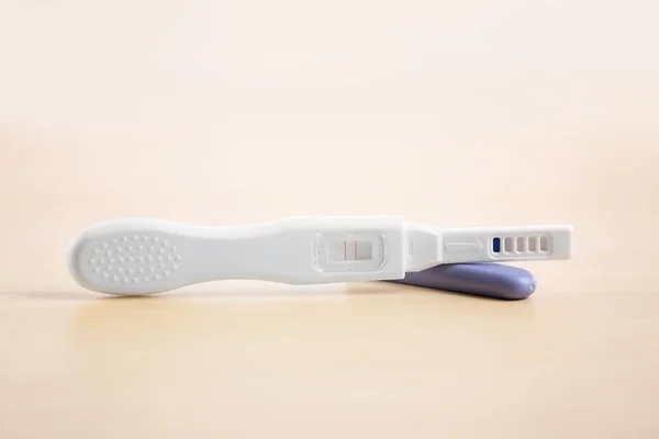 Pregnancy test on wooden table — Stock Photo, Image