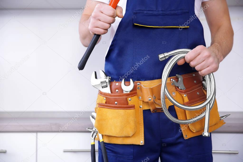 Plumber holding pipe wrench