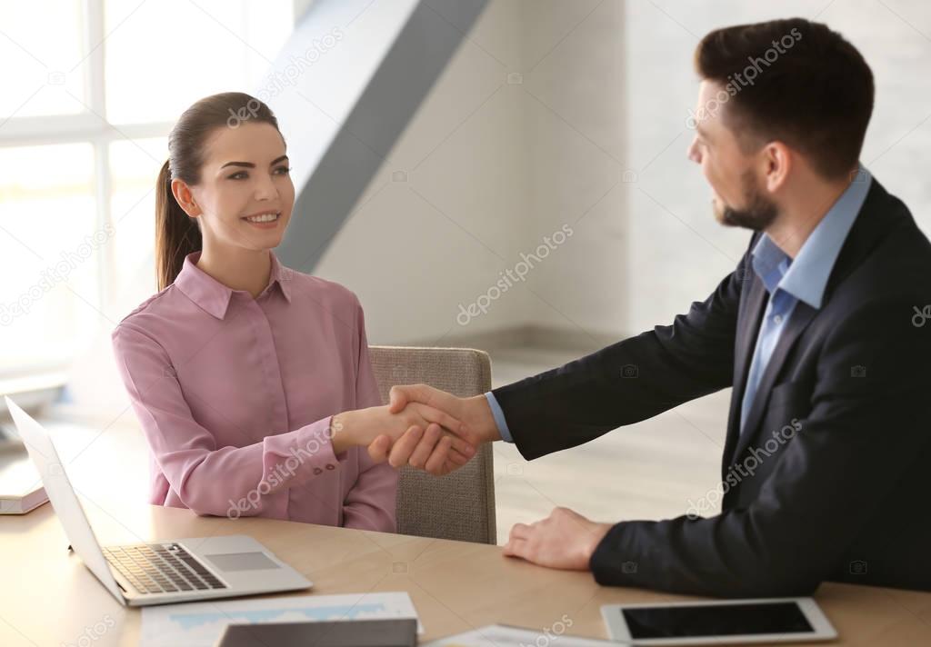 Manager and client shaking hands