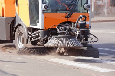Municipal car for cleaning roads and sidewalks outdoors clipart