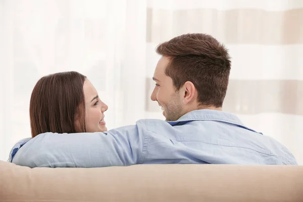 Happy couple resting on couch — Stock Photo, Image