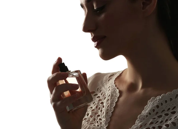 Beautiful young woman with bottle of perfume — Stock Photo, Image