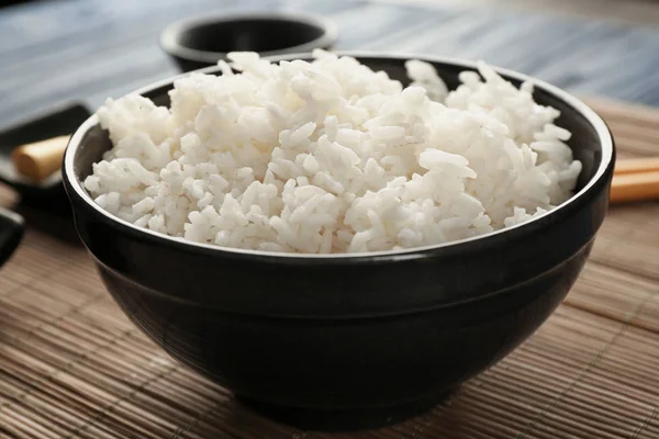 Bowl of rice on bamboo mat — Stock Photo, Image