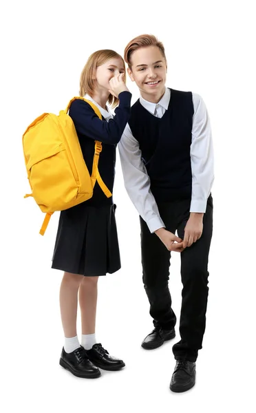 Menina bonito e menino em uniforme escolar no fundo branco — Fotografia de Stock