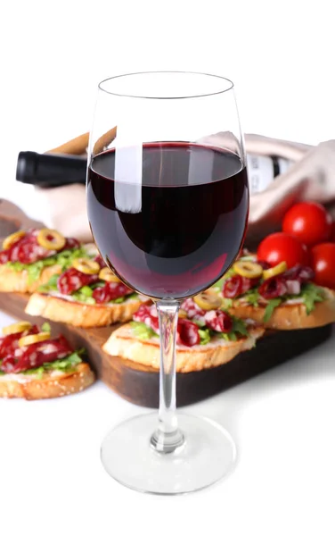 Glass of wine and tasty bruschettas — Stock Photo, Image