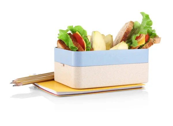 Коробка с едой и канцелярскими принадлежностями на белом фоне — стоковое фото