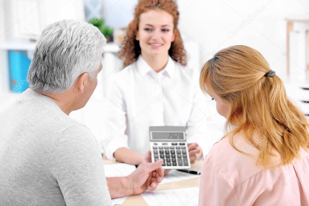 Insurance agent showing calculator 