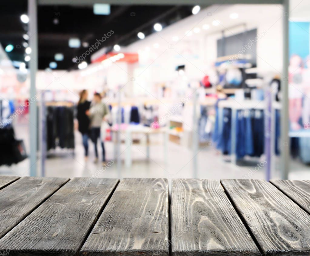 Wooden table on blurred shopping mall 