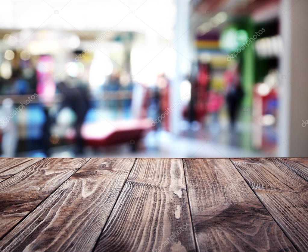 Wooden table on blurred shopping mall