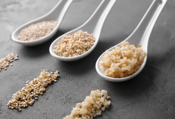 Three ceramic spoons with quinoa grains — Stock Photo, Image