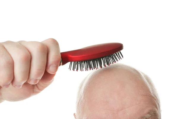 Bald senior man with hair brush on white background, closeup — Stock Photo, Image