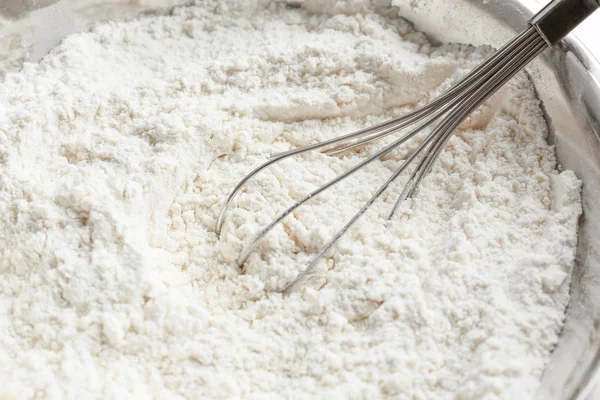 Bowl with flour and whisk — Stock Photo, Image