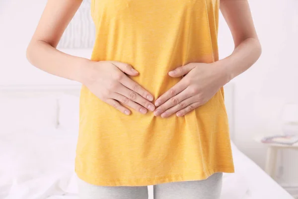 Woman with hands on her belly — Stock Photo, Image