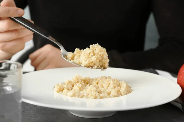 Woman eating quinoa porridge — Stock Photo, Image
