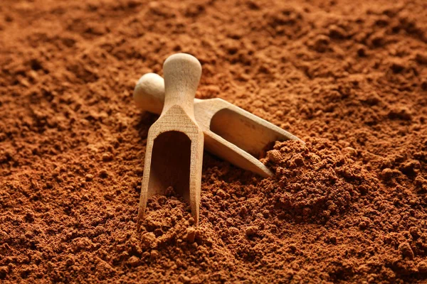 Wooden scoops on cocoa powder — Stock Photo, Image