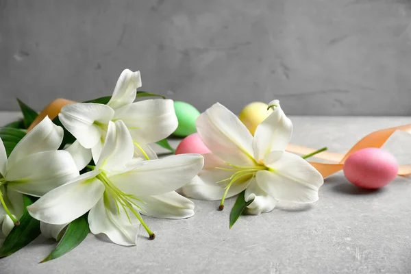 Beautiful lilies with eggs and ribbon — Stock Photo, Image