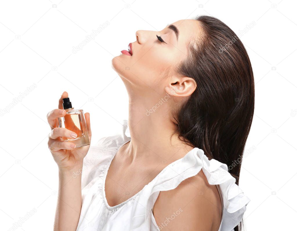 Beautiful young woman with bottle of perfume 