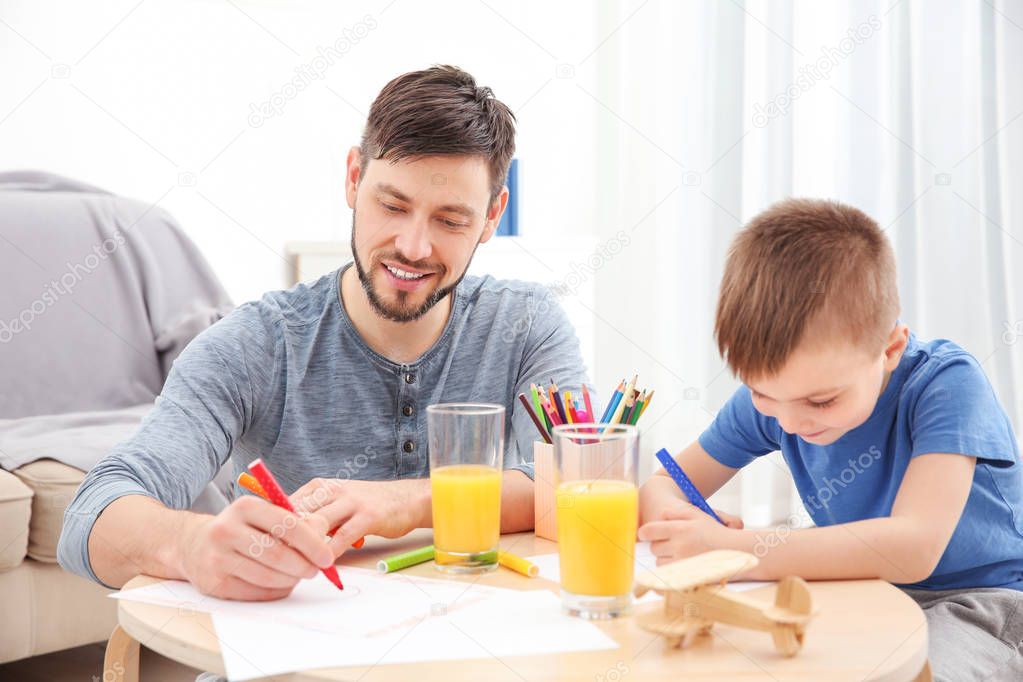 Father and son drawing pictures 