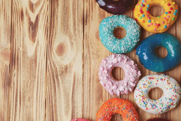 Donuts glacés sur fond en bois — Photo