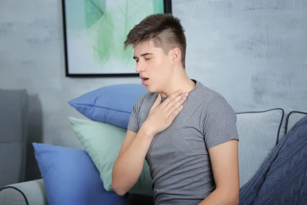 Sick young man coughing at home — Stock Photo, Image
