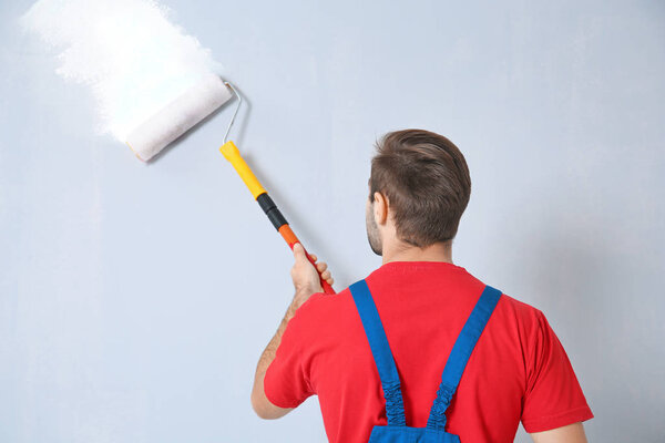 worker painting wall 