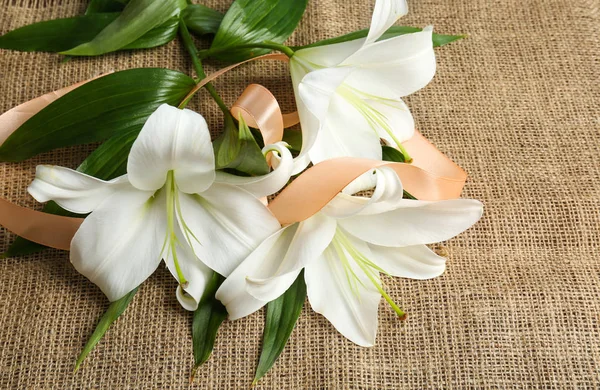 Beautiful lilies and ribbon — Stock Photo, Image