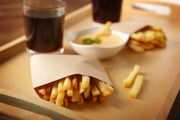 Tray with tasty fries, cheese sauce — Stock Photo, Image