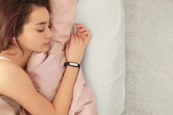 Young woman with sleep tracker