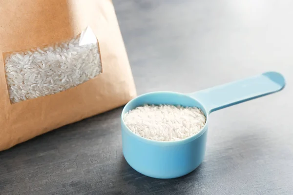 Measure scoop with rice — Stock Photo, Image