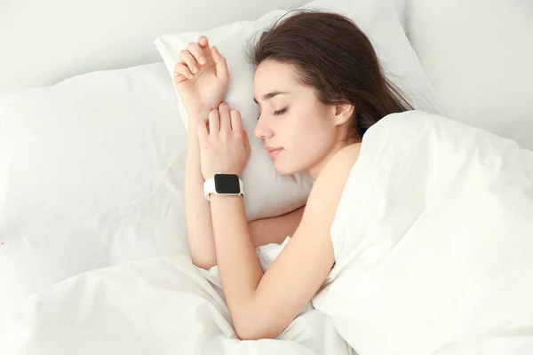 Young woman with sleep tracker
